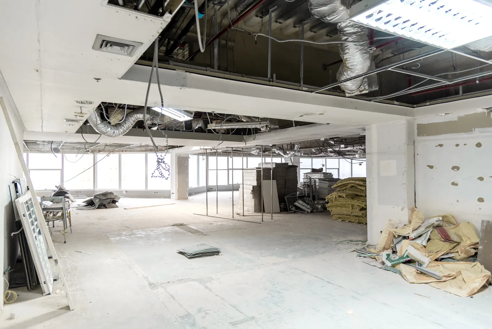 Commercial interior mid-demolition with ceiling systems exposed
