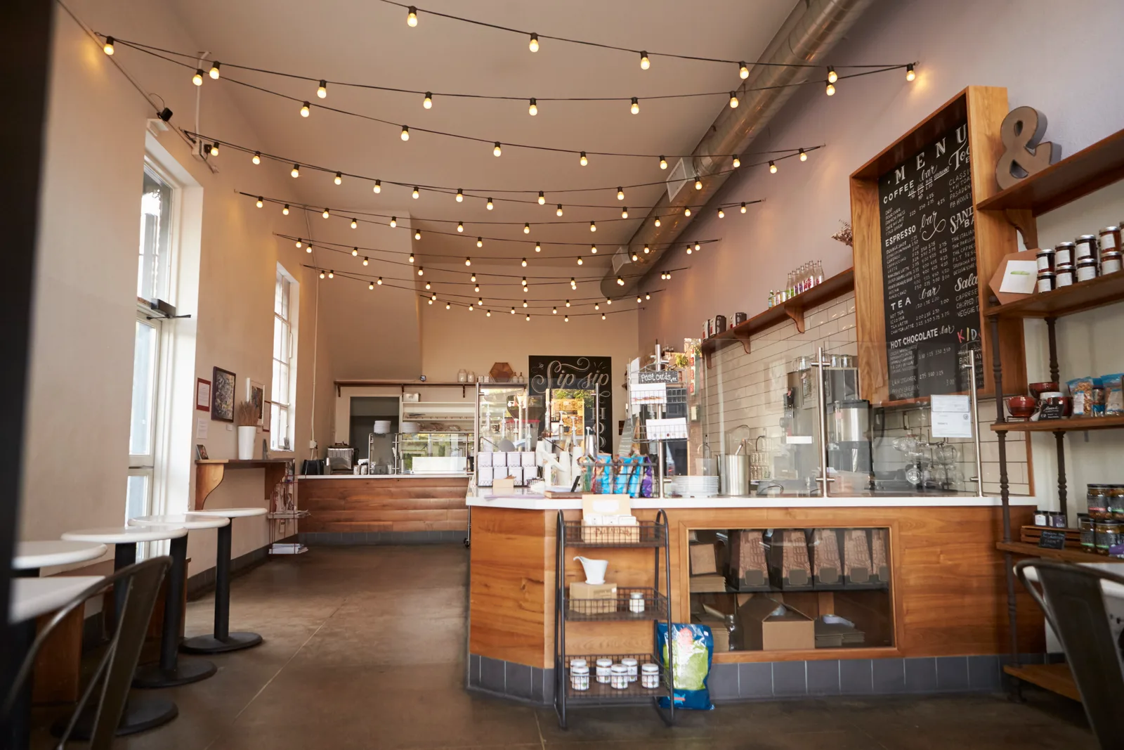 Completed café fit-out with custom wood service counter and feature lighting