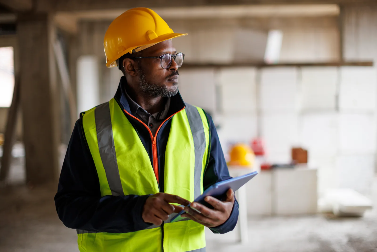Site supervisor reviewing progress on a tablet during a commercial renovation