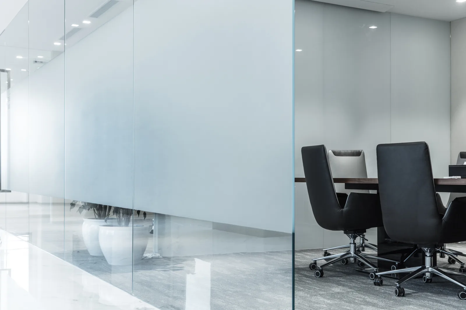 Completed tenant improvement with frosted-glass partitions and boardroom